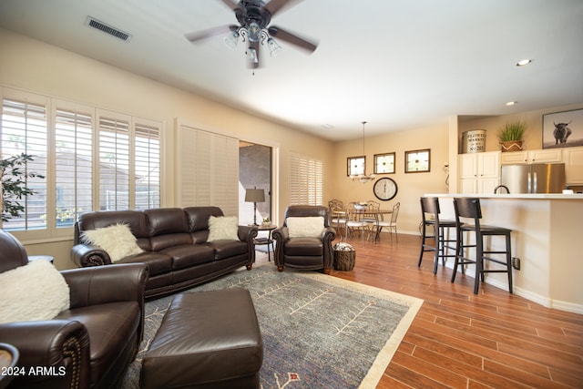 living room with hardwood / wood-style flooring and ceiling fan