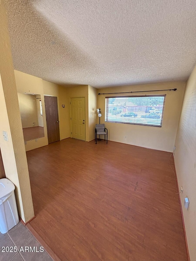 4910 E Foothills Dr, Sierra Vista, AZ 85635 - unfurnished living room featuring wood finished floors and a textured ceiling