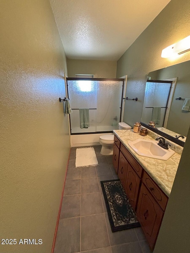 4910 E Foothills Dr, Sierra Vista, AZ 85635 - bathroom featuring a textured wall, vanity, tile patterned flooring, tub / shower combination, and toilet