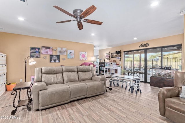 living area with light wood finished floors, ceiling fan, and recessed lighting