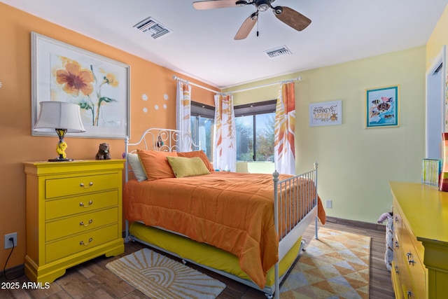 bedroom with visible vents, dark wood finished floors, baseboards, and ceiling fan