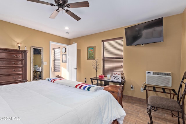 bedroom featuring baseboards, ceiling fan, an AC wall unit, light wood-style floors, and recessed lighting