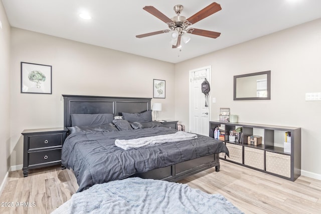 bedroom with light hardwood / wood-style flooring and ceiling fan