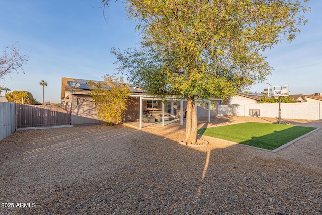 rear view of house featuring solar panels