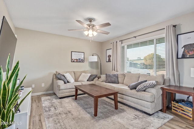 living room featuring ceiling fan and light wood-type flooring