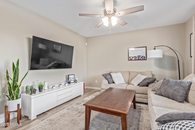 living room featuring ceiling fan and light wood-type flooring