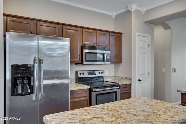 1821 S Navajo Way, Chandler, AZ 85286 - kitchen with appliances with stainless steel finishes, ornamental molding, and arched walkways