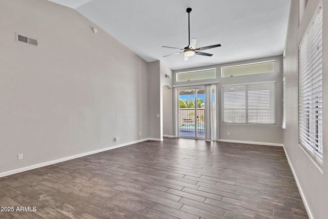 1821 S Navajo Way, Chandler, AZ 85286 - empty room with a ceiling fan, dark wood-style flooring, vaulted ceiling, and arched walkways