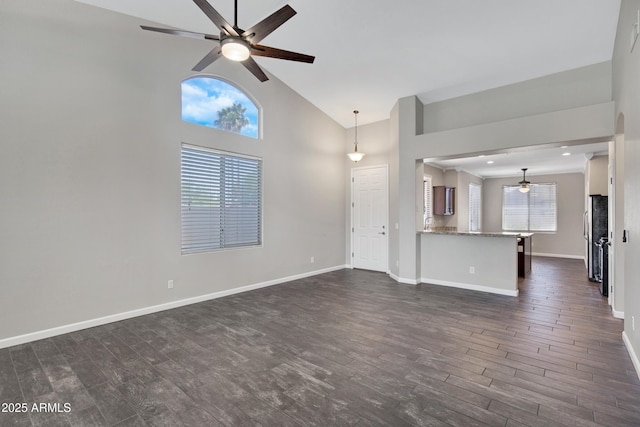 1821 S Navajo Way, Chandler, AZ 85286 - unfurnished living room with a ceiling fan, dark wood-style flooring, and high vaulted ceiling