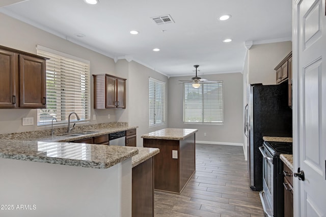 1821 S Navajo Way, Chandler, AZ 85286 - kitchen with appliances with stainless steel finishes, a kitchen island, crown molding, a ceiling fan, and wood finished floors