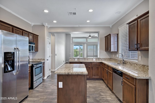 1821 S Navajo Way, Chandler, AZ 85286 - kitchen with appliances with stainless steel finishes, ornamental molding, ceiling fan, a center island, and a peninsula