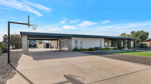 view of front of property with central AC unit and a carport