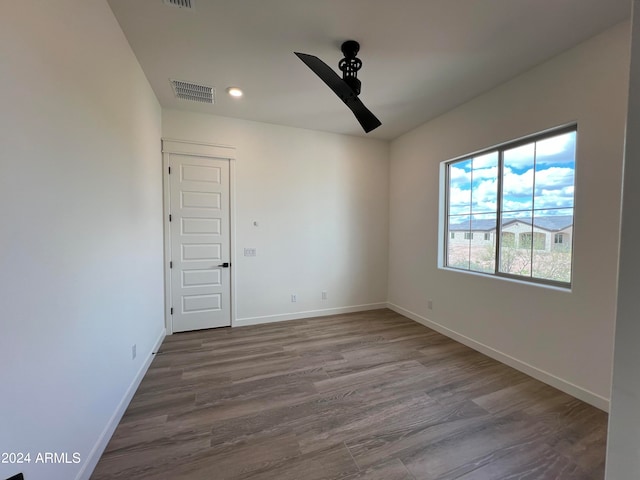 empty room featuring ceiling fan and hardwood / wood-style floors