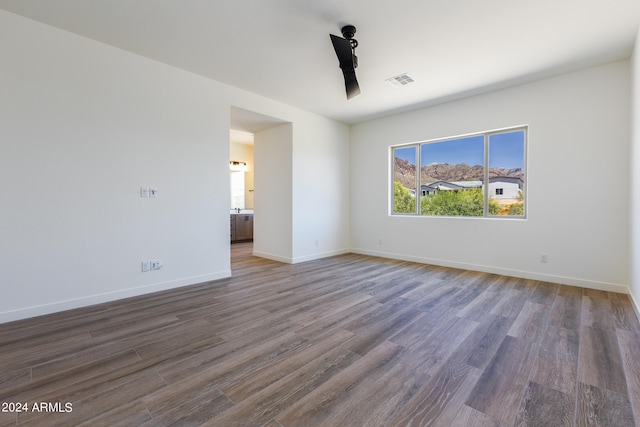 unfurnished room with dark hardwood / wood-style floors