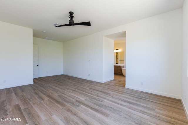 empty room with ceiling fan and hardwood / wood-style flooring