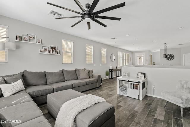 living room featuring dark wood-type flooring, a wealth of natural light, and ceiling fan