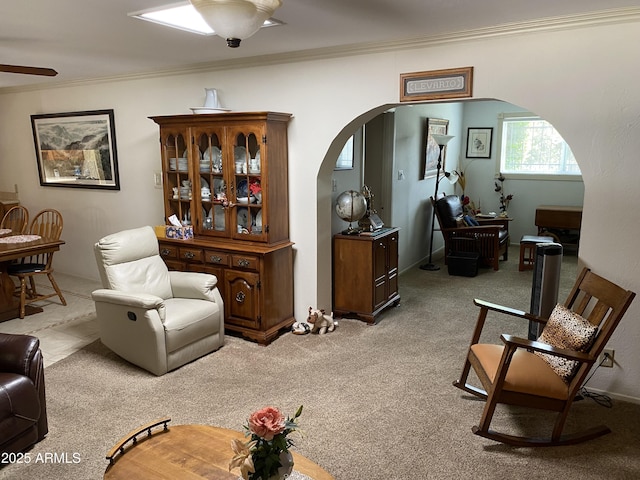 6637 E Culver St, Scottsdale, AZ 85257 - living room featuring arched walkways, ornamental molding, light colored carpet, and a ceiling fan