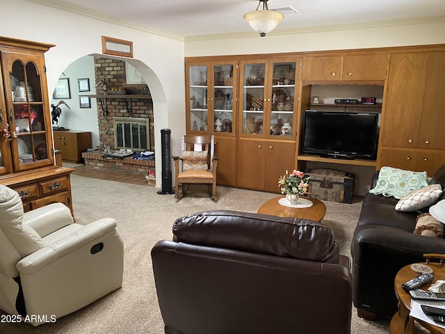 6637 E Culver St, Scottsdale, AZ 85257 - living room featuring crown molding, carpet, a brick fireplace, and arched walkways
