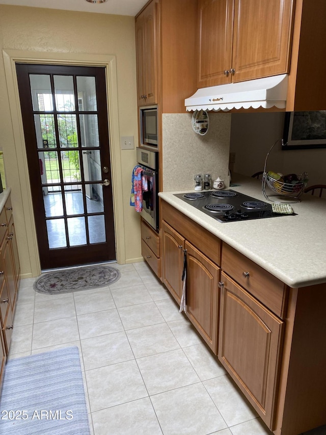 6637 E Culver St, Scottsdale, AZ 85257 - kitchen with stainless steel oven, under cabinet range hood, black electric cooktop, light countertops, and built in microwave
