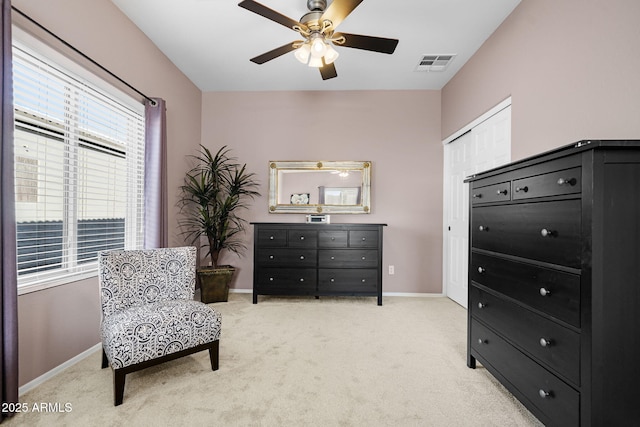 living area featuring ceiling fan and light carpet