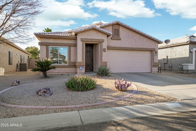 view of front of property featuring a garage and central AC