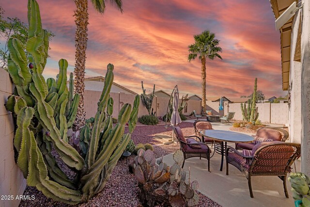 view of patio terrace at dusk