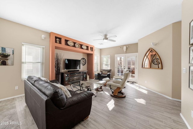 living room featuring french doors, ceiling fan, and light hardwood / wood-style floors