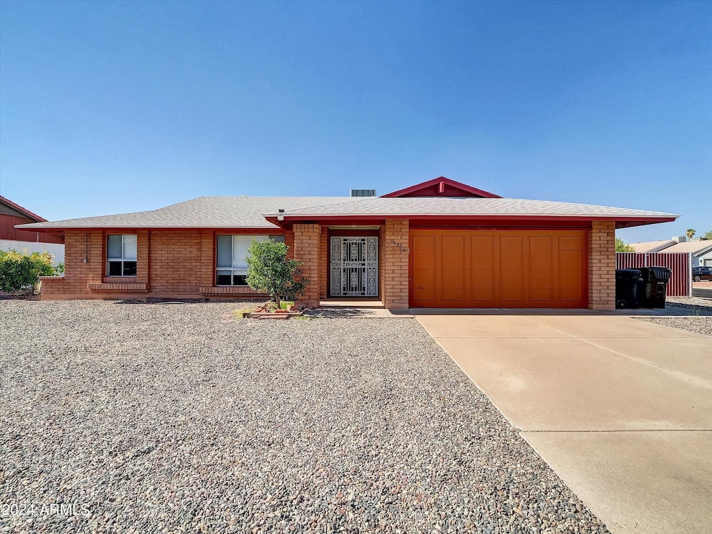 ranch-style home featuring a garage