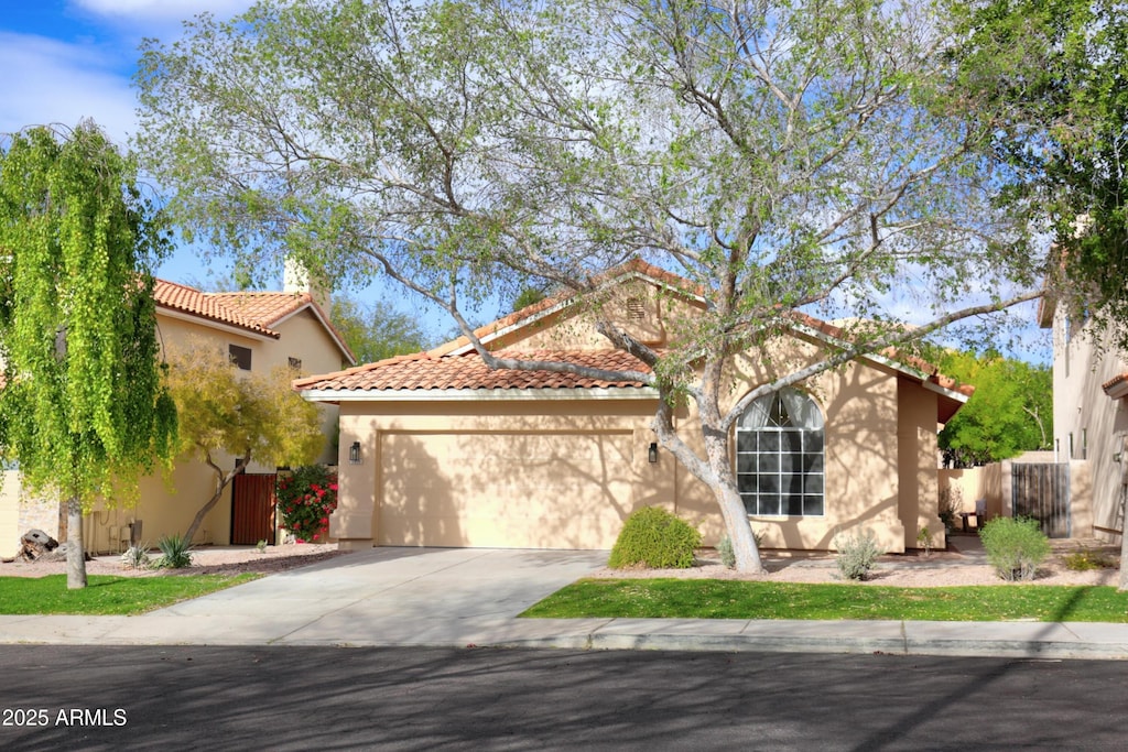 mediterranean / spanish-style house featuring a garage