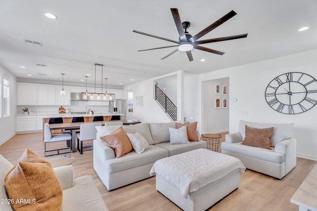 3592 W Cobalt Ct, San Tan Valley, AZ 85144 - living area with a ceiling fan, light wood-style floors, recessed lighting, stairway, and baseboards