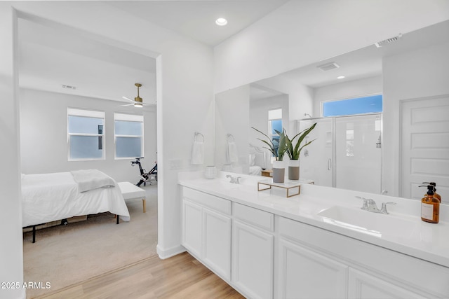 3592 W Cobalt Ct, San Tan Valley, AZ 85144 - ensuite bathroom with wood finished floors, a shower stall, double vanity, a ceiling fan, and recessed lighting