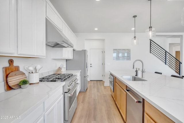 3592 W Cobalt Ct, San Tan Valley, AZ 85144 - kitchen with a sink, exhaust hood, appliances with stainless steel finishes, light wood-type flooring, and light stone countertops