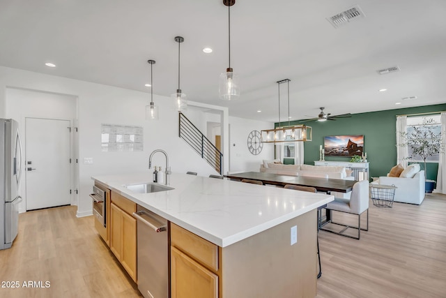 3592 W Cobalt Ct, San Tan Valley, AZ 85144 - kitchen with a sink, appliances with stainless steel finishes, open floor plan, light wood finished floors, and recessed lighting