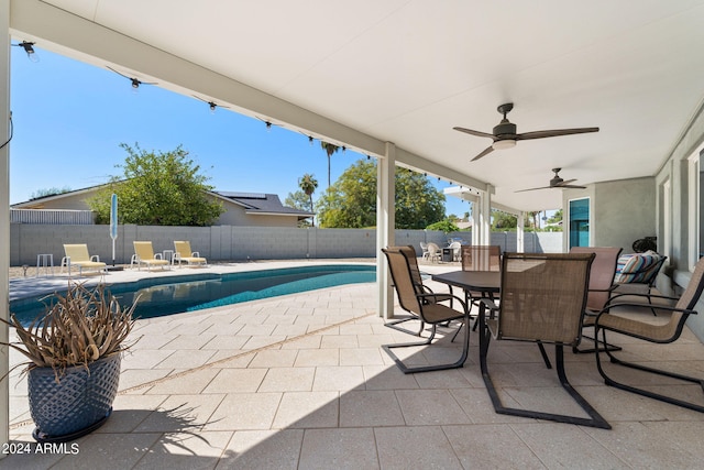 view of swimming pool with ceiling fan and a patio area