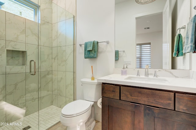 bathroom featuring vanity, toilet, walk in shower, and tile patterned floors