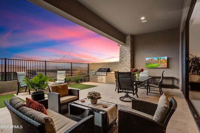 view of patio / terrace featuring grilling area, an outdoor hangout area, and an outdoor kitchen