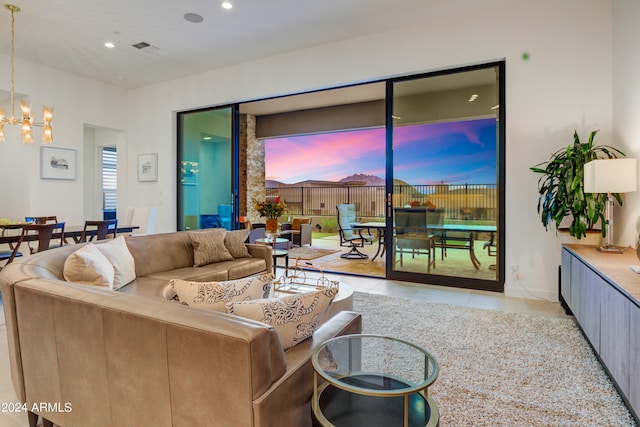 living room featuring light tile patterned floors and an inviting chandelier