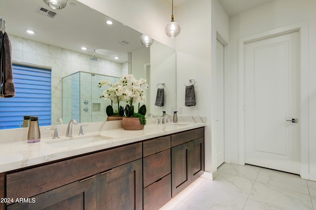 bathroom featuring vanity and an enclosed shower