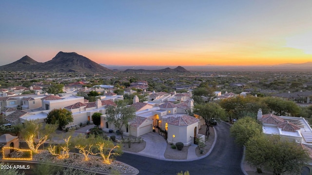 aerial view at dusk featuring a mountain view