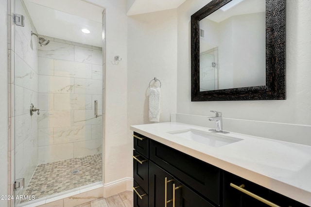 bathroom featuring vanity and a shower with door