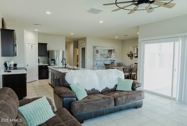 living room featuring light tile patterned floors, recessed lighting, visible vents, and ceiling fan