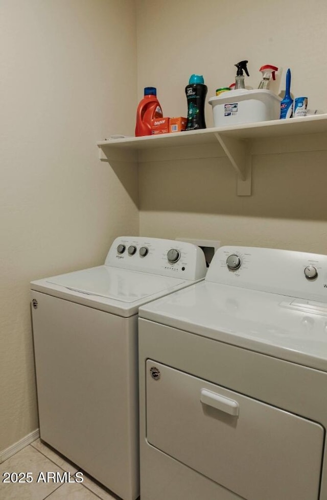 washroom with washer and clothes dryer, laundry area, and light tile patterned floors