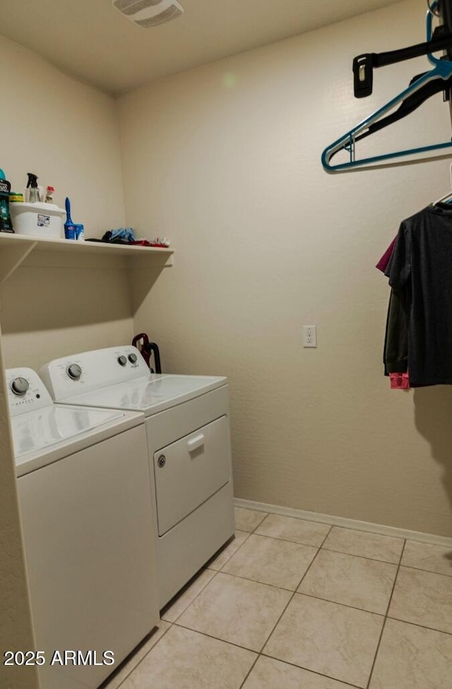 laundry room with laundry area, light tile patterned flooring, visible vents, and washing machine and clothes dryer