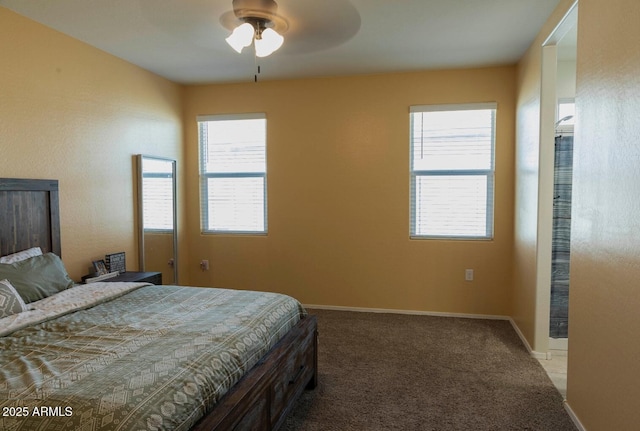 carpeted bedroom featuring baseboards and ceiling fan