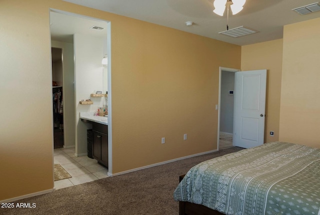 bedroom with visible vents, baseboards, and light colored carpet