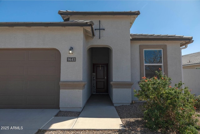 view of front of home featuring stucco siding and a garage