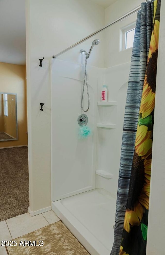 full bath featuring tile patterned floors and a stall shower