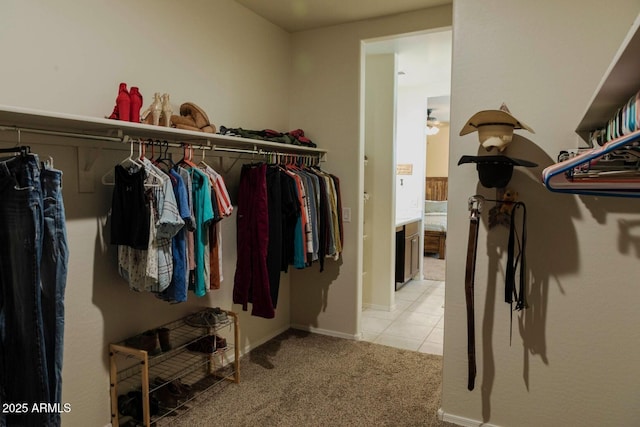 spacious closet with light tile patterned floors and light colored carpet