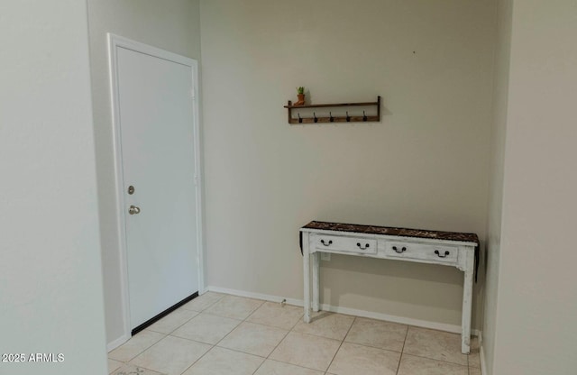 interior space with baseboards and light tile patterned flooring