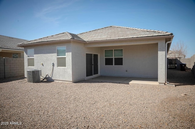 back of property featuring a patio, fence, central AC, stucco siding, and a tile roof